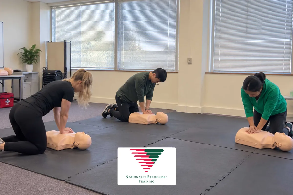 A trainer demonstrating CPR technique during practical first aid training — HLTAID011 Provide First Aid, SNS College Perth